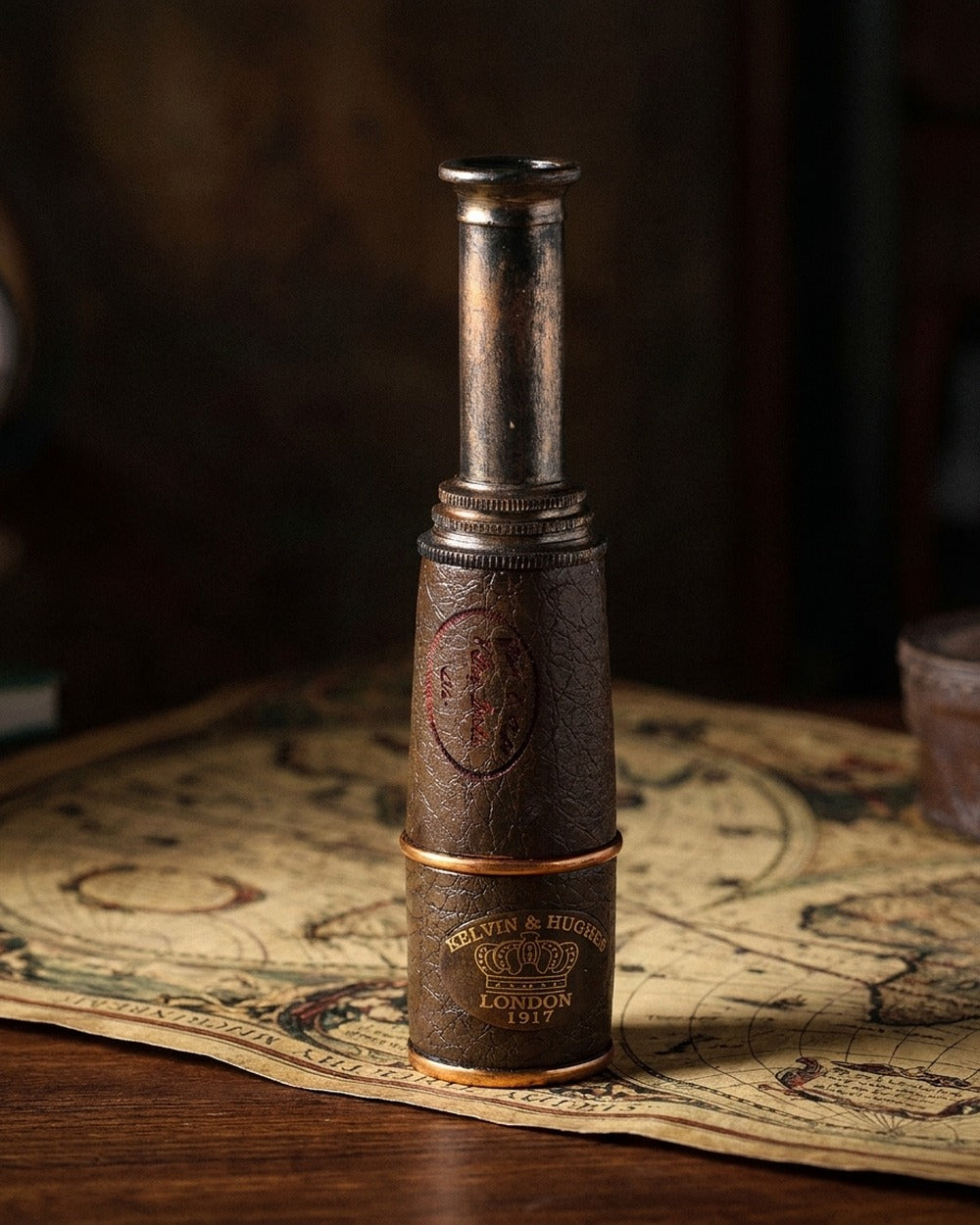 The 1917 Spyglass — leather-and-brass spyglass standing on an antique map